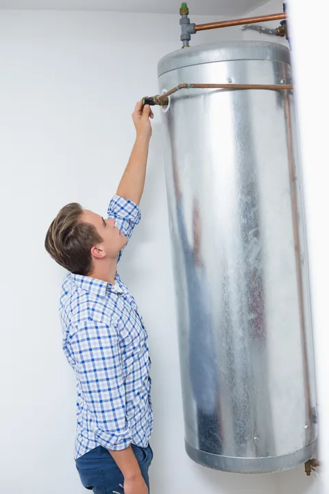 Technician servicing a hot water heater